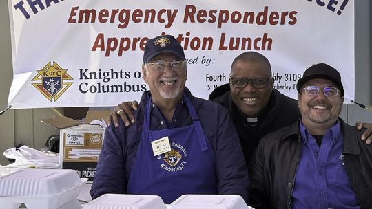Photo by Teresa Kendrick Joe Oldham, Fr. Chris Unachukwu and Jason Foreman hand out delicious barbecue meals and smiles at the annual luncheon to acknowledge first responders.