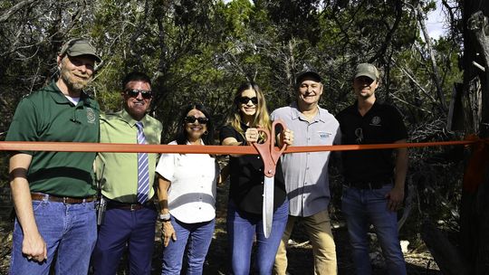 Photo by Natalie Frels Hays County Director of Parks and Natural Resources Karl Flocke, Deputy County Administrator Tucker Furlow, Hays County Commissioner Debbie Ingalsbe, Hays County Commissioner Morgan Hammer, Executive Director of the Watershed Association David Baker, and San Marcos Greenbelt A