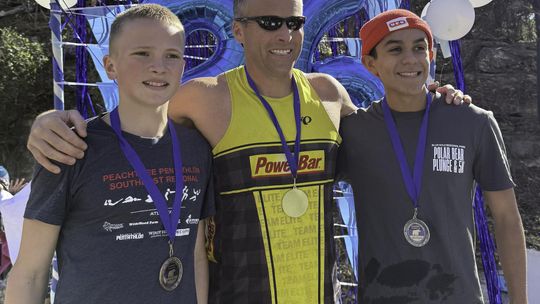 Submitted Photo. Winners of the 2026 Polar Bear Plunge 5K race pose after their cool down plunge in Cypress Creek. Taking first place was James Bales, center. The second place runner was Nathan Cisneros, right, and in third place was Noah Bales, left.