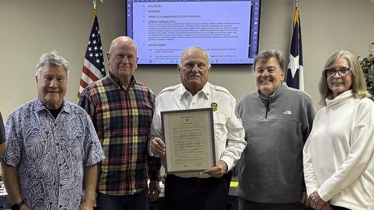 Photo by Teresa Kendrick Retiring Fire Chief Carroll Czichos holds the proclamation that declares December 31, 2025 as Fire Chief Czichos Day. Witnessing the event are council members Chris Sheffield, left, David Cohen, Mayor Jim Chiles, Czichos, and council members Bo Bowman, Rebecca Minnick and Bo