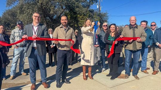 Submitted Photo WSD Superintendent Dr. Greg Bonewald, left, Hays County Commissioner Morgan Hammer, center, and Mayor Jim Chiles, right, along with city council members and other well-wishers during the dedication.