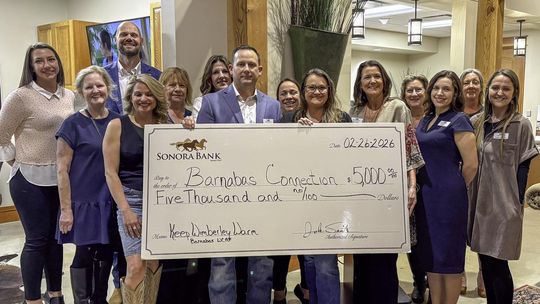 Photo by Teresa Kendrick Josh Smith of Sonora Bank donates $5,000 to the Barnabas Connection “Keep Wimberley Warm” program.