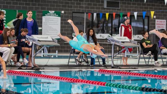 Photo by Paul Mayhew/paulmayhewphotography.com Off the blocks is junior Gracie Colyear for the 400 yd freestyle relay that will take them to State.