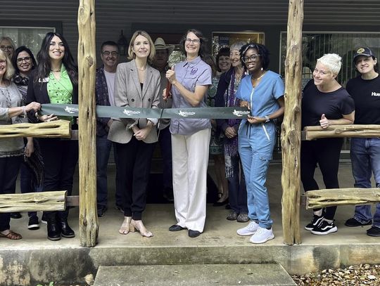 Holding the scissors at the ribbon cutting for Body Insight is Alaria Godwin. Submitted Photo.