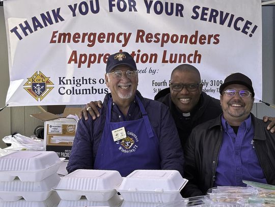 Photo by Teresa Kendrick Joe Oldham, Fr. Chris Unachukwu and Jason Foreman hand out delicious barbecue meals and smiles at the annual luncheon to acknowledge first responders.