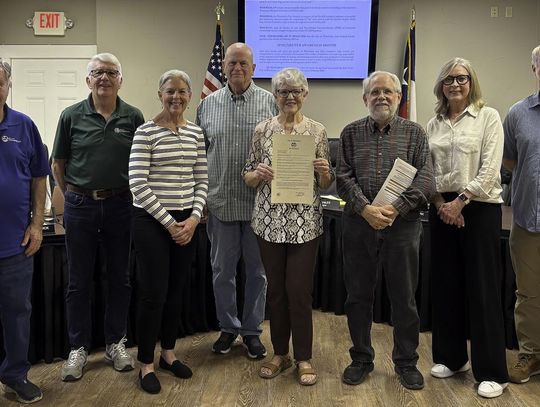 Photo by Teresa Kendrick Mayor Jim Chiles recognizes the work of the Wimberley TNR program. In the Center, holding the Proclamation, is Marcia Sanderson.