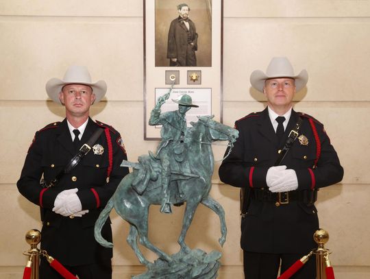 Daily Record photo by John Clark Hays County Sheriff’s Office Honor Guard members left: Mark Opiela and right: Scott Zediker, with the statue and portrait presented in the Jack Hays Collection.
