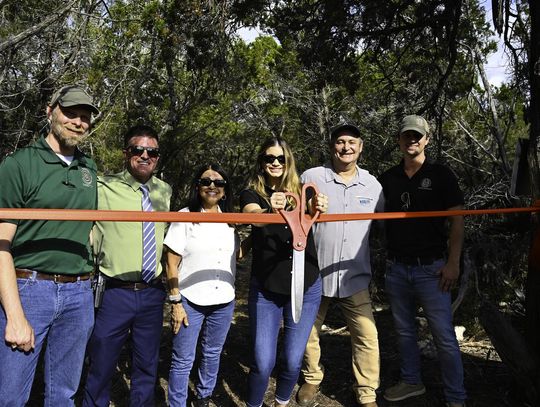 Photo by Natalie Frels Hays County Director of Parks and Natural Resources Karl Flocke, Deputy County Administrator Tucker Furlow, Hays County Commissioner Debbie Ingalsbe, Hays County Commissioner Morgan Hammer, Executive Director of the Watershed Association David Baker, and San Marcos Greenbelt A