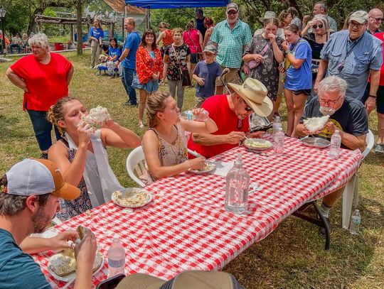 Photo by Teresa Kendrick Owing to the expressions on the faces of onlookers, competitors in past Pie Eating contests gave it their all to claim the prize.