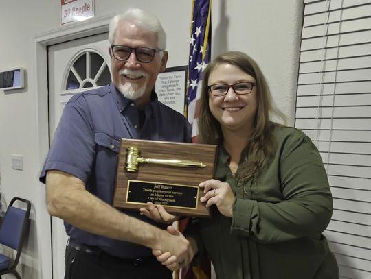 Submitted Photo Outgoing Mayor of Woodcreek Jeff Rasco receives an award for his service to Woodcreek. He is shown here receiving a gavel plaque from incoming Mayor Debra Hines.