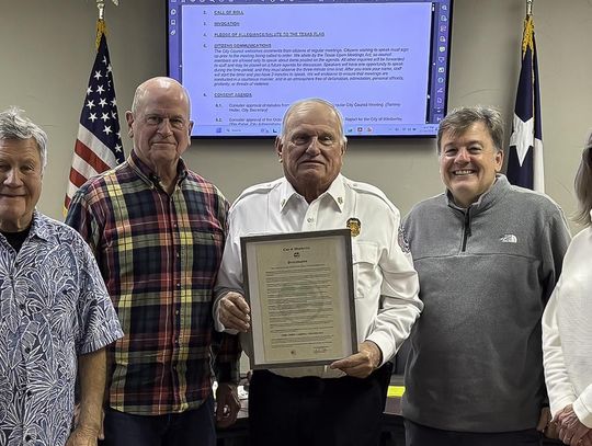 Photo by Teresa Kendrick Retiring Fire Chief Carroll Czichos holds the proclamation that declares December 31, 2025 as Fire Chief Czichos Day. Witnessing the event are council members Chris Sheffield, left, David Cohen, Mayor Jim Chiles, Czichos, and council members Bo Bowman, Rebecca Minnick and Bo