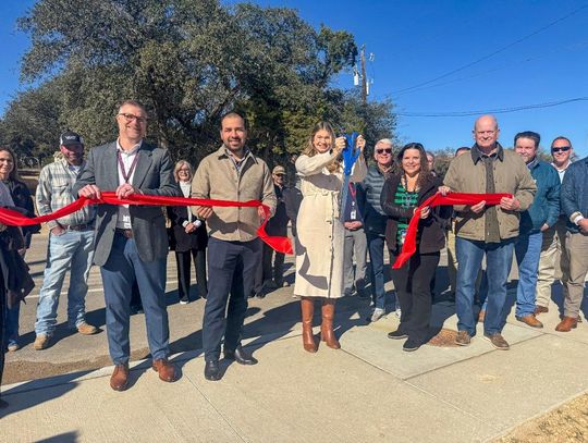 Submitted Photo WSD Superintendent Dr. Greg Bonewald, left, Hays County Commissioner Morgan Hammer, center, and Mayor Jim Chiles, right, along with city council members and other well-wishers during the dedication.