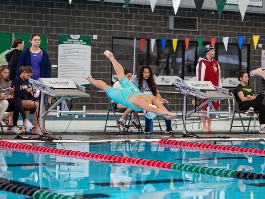 Photo by Paul Mayhew/paulmayhewphotography.com Off the blocks is junior Gracie Colyear for the 400 yd freestyle relay that will take them to State.