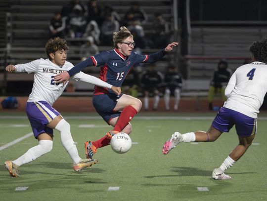Hunter Hodgson moves the ball in the air during the Texans home game against Marble Falls.  Photo by Julie Albini/albini.smugmug.com