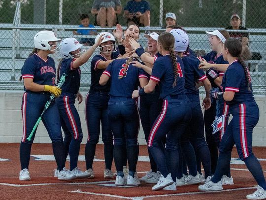 Photo by Paul Mayhew/paulmayhewphotography.com Teammates celebrate Ella Patek’s homerun.