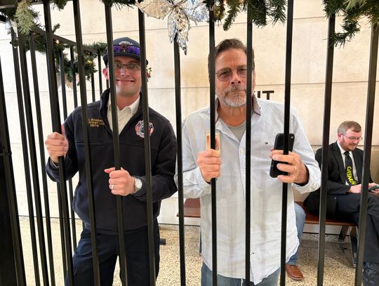 Wimberley Fire and Rescue Chief Chris Robbins and EMS Director Ken Strange were part of a roundup of Hays County officials put behind bars on Friday. Photo by Teresa Kendrick