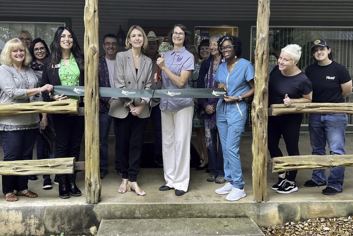 Holding the scissors at the ribbon cutting for Body Insight is Alaria Godwin. Submitted Photo.