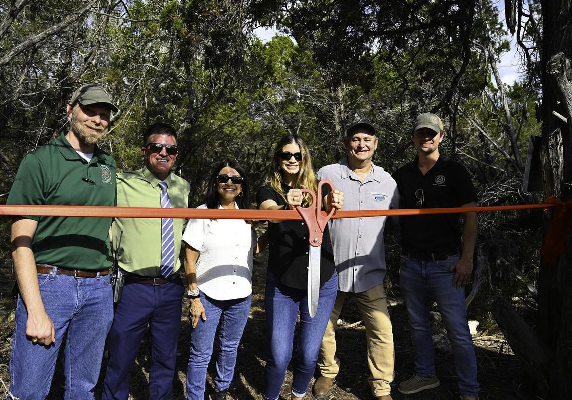 Photo by Natalie Frels Hays County Director of Parks and Natural Resources Karl Flocke, Deputy County Administrator Tucker Furlow, Hays County Commissioner Debbie Ingalsbe, Hays County Commissioner Morgan Hammer, Executive Director of the Watershed Association David Baker, and San Marcos Greenbelt A