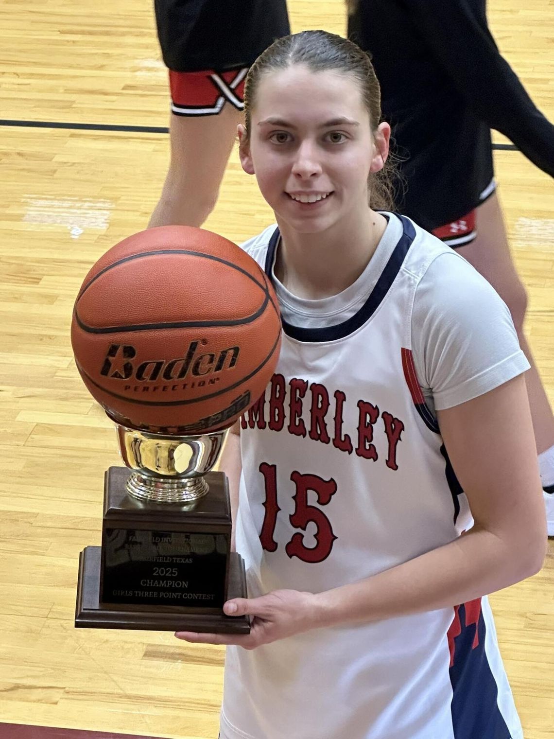 Photo submitted by Wimberley ISD Ainsley Stotley holds her trophy after winning the three-point contest at the Fairfield Tournament. 