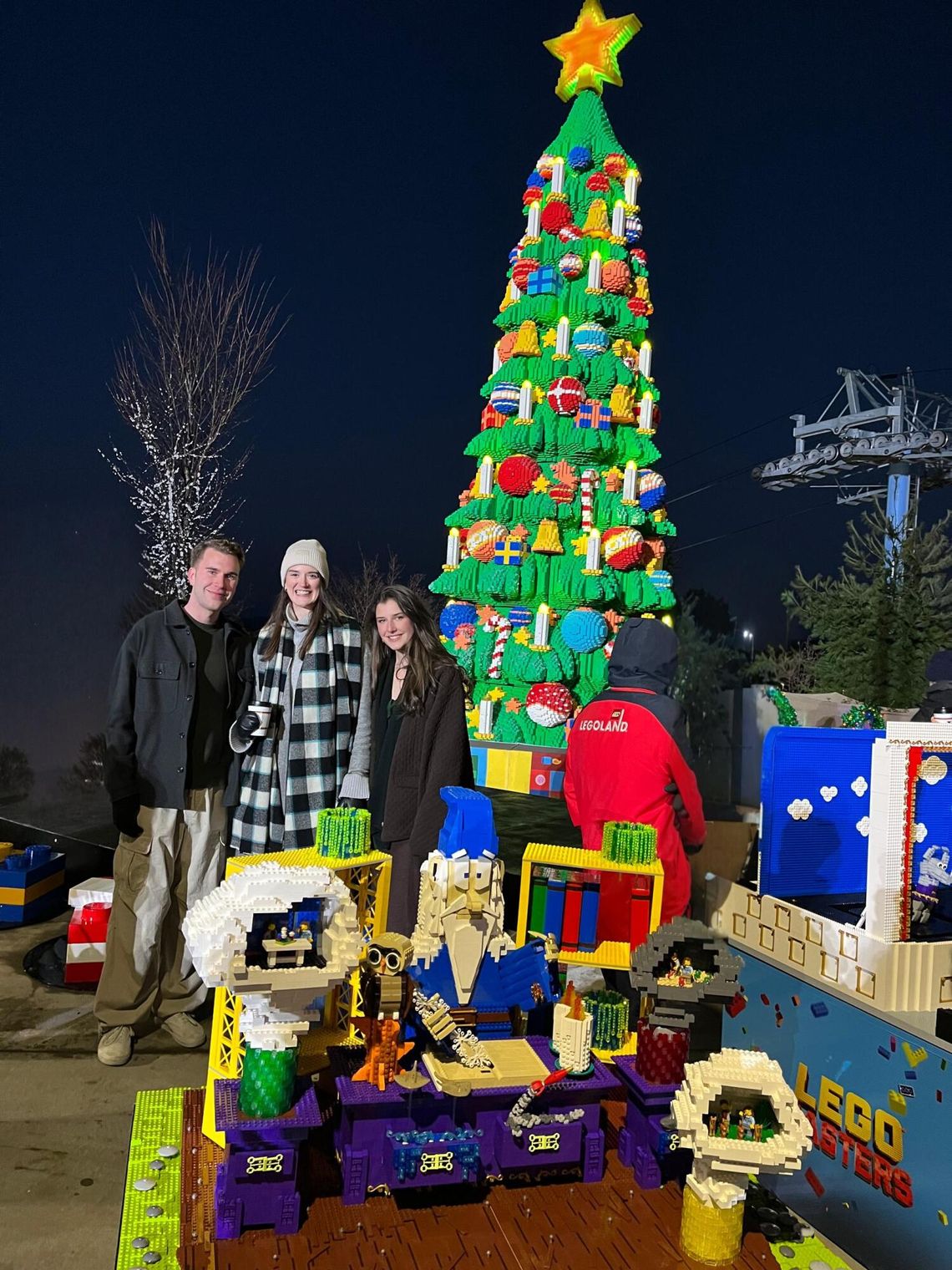 Photo by Denise Summers FOX’s Season 5 LEGO Masters Ian, left, and Sage Summers, center, pose with Brick Master and Judge on FOX LEGO Masters program Amy Corbett as they officially light the NYC LEGOLAND Christmas Tree.