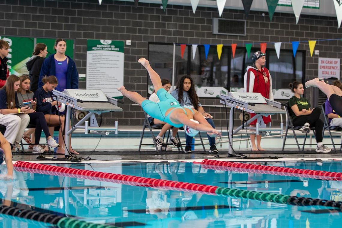 Photo by Paul Mayhew/paulmayhewphotography.com Off the blocks is junior Gracie Colyear for the 400 yd freestyle relay that will take them to State.