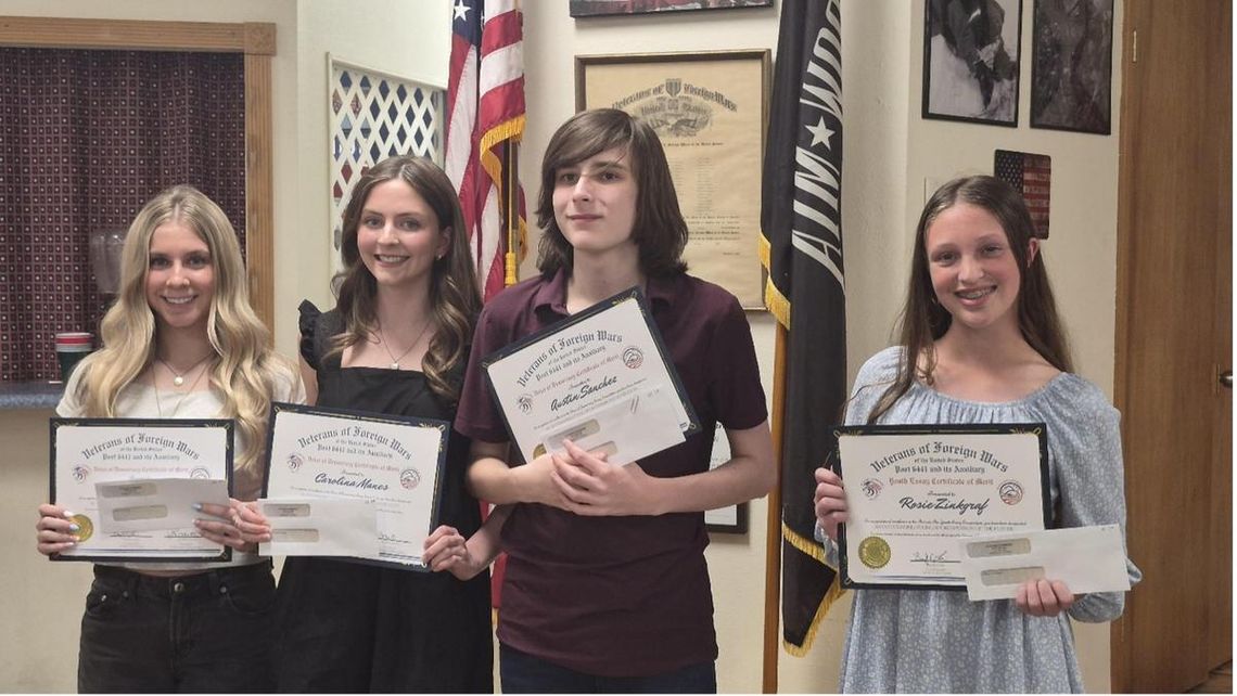 Submitted Photo VFW Post 6441 Commander Brady Love awarded Audio and essay winners, left to right, Quinn Jennings, Carolina Manes, Austin Sanchez and Rosie Zinkgraf in the Voice of Democracy and Patriot Pen contests. Not pictured is Tinley Williams.