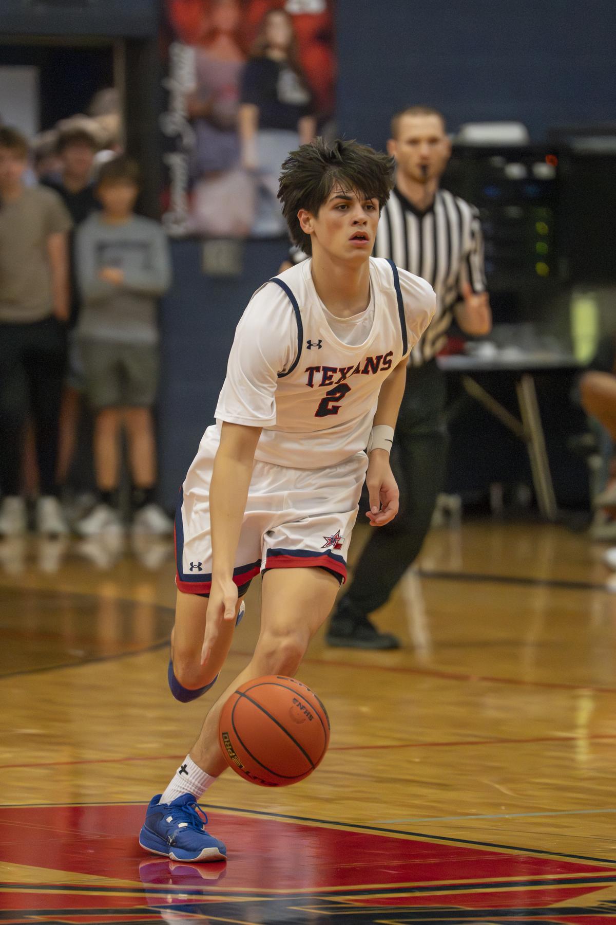 Harley Peacock #2 with the drive into the lane during the Texans district win...