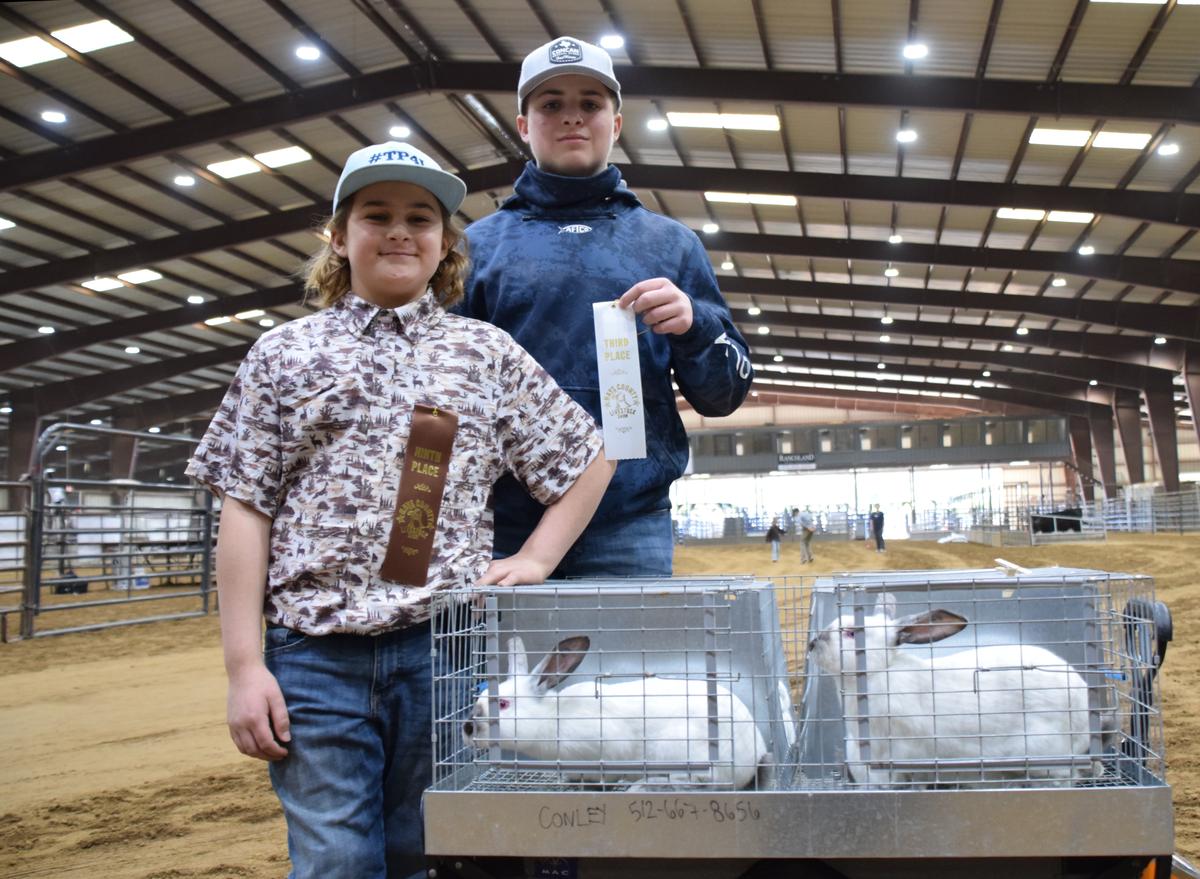 Forrest Conley and Abram Conley show off their market rabbits.