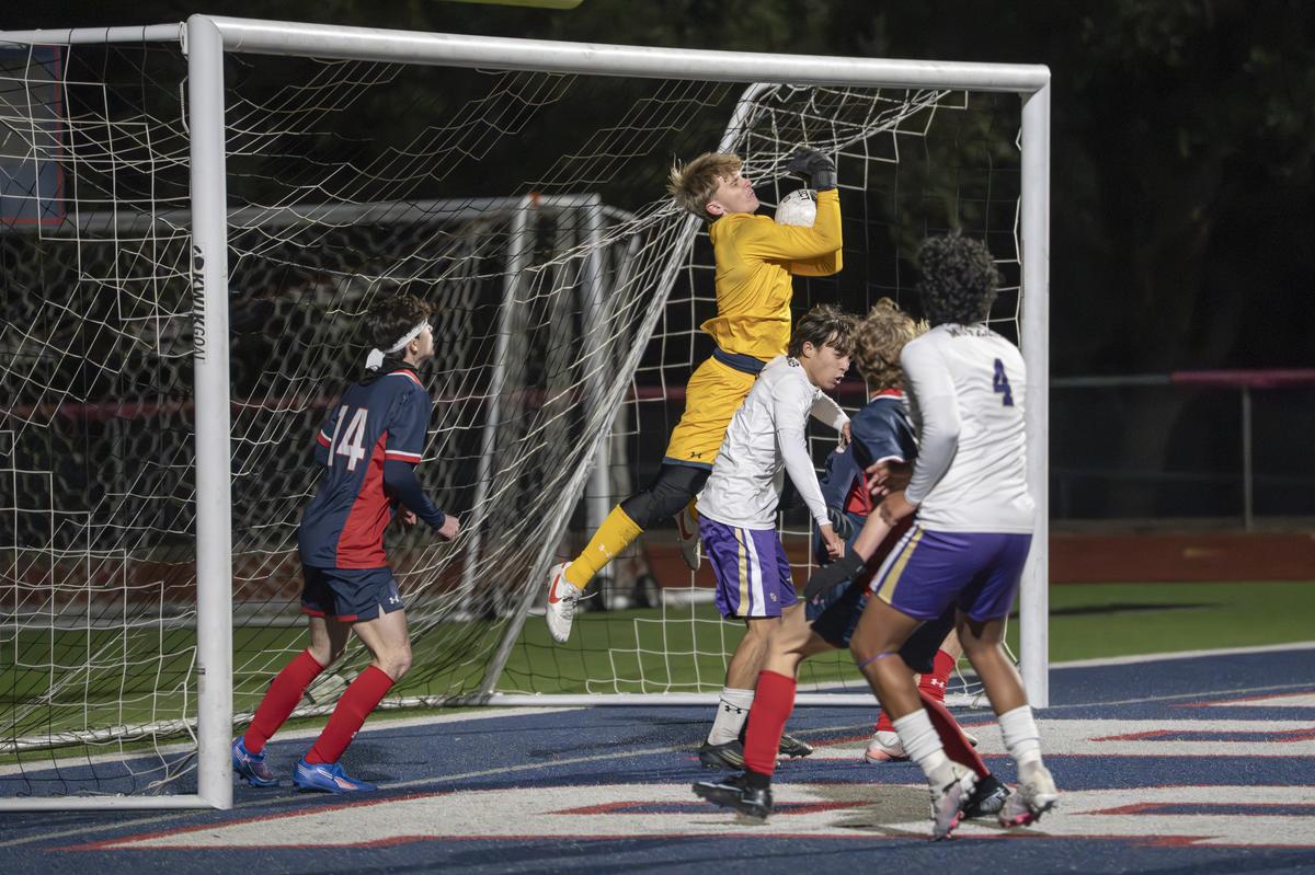 Keith Cook, #1, makes the save for the Texans to help seal the win against th...