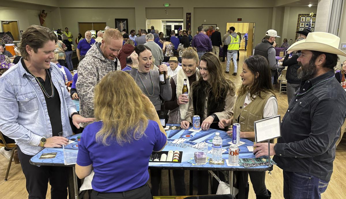 Photo by Teresa Kendrick Lady luck smiles on a player at the Blackjack table.