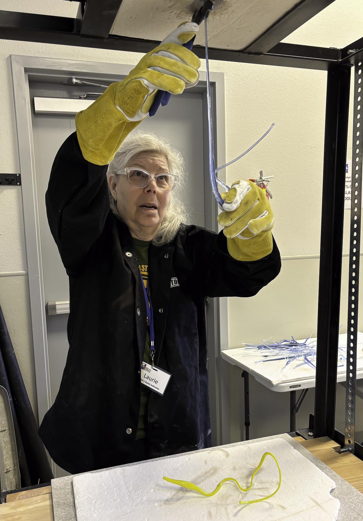 Photo by Teresa Kendrick Artist Laurie Rich working with molten glass in a pr...