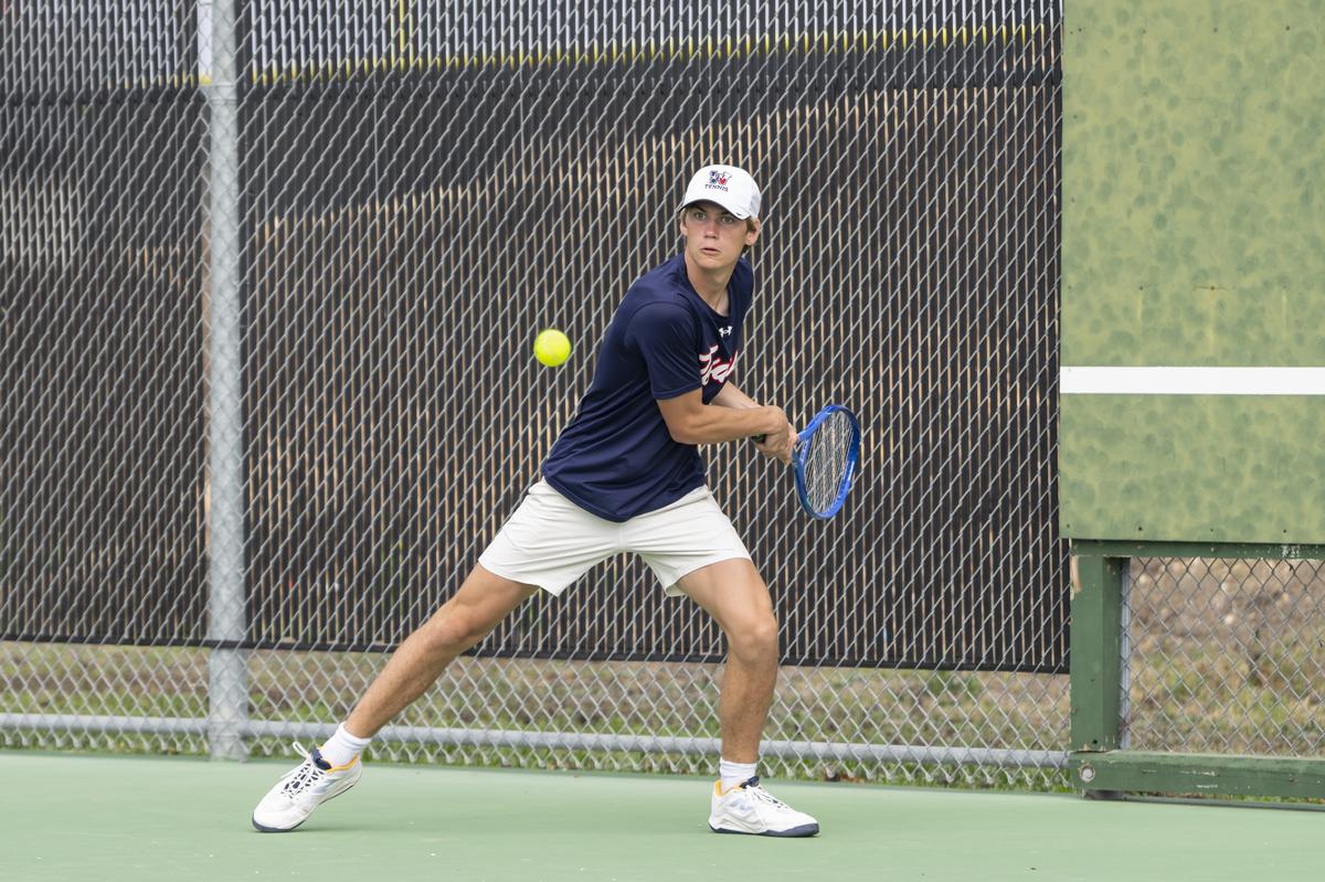 Banton Kirchner returns the ball in boys doubles competition at the Pflugervi...