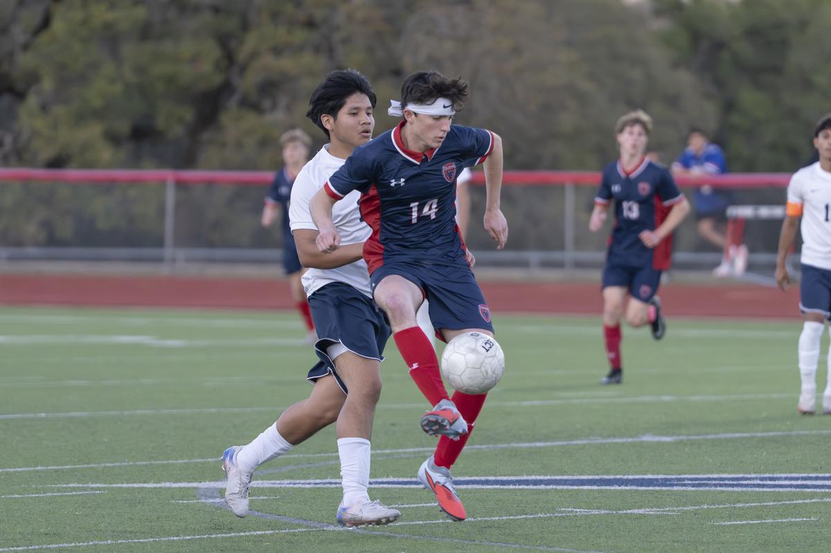Photo by Julie Albini/albini.smugmug.com Micah Espinoza, #14, wins the ball.