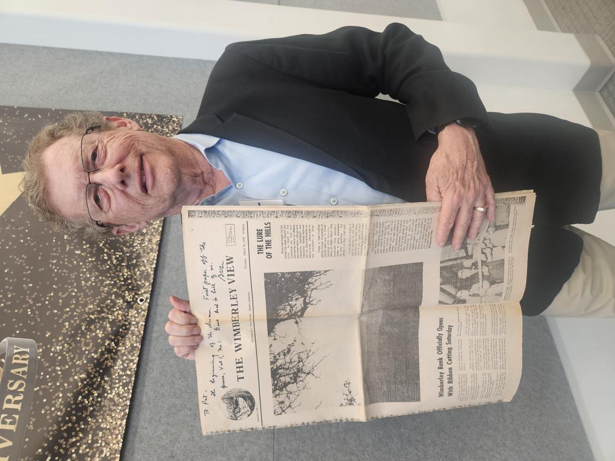 Founder Patrick Cox holds up the first legible issue of the inaugural edition...