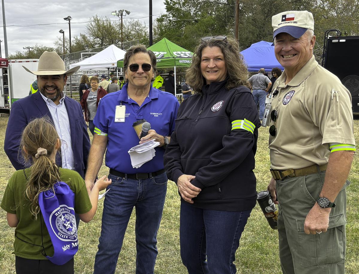 Photo by Teresa Kendrick A young resident talks with Hays Co. Judge Candidate...