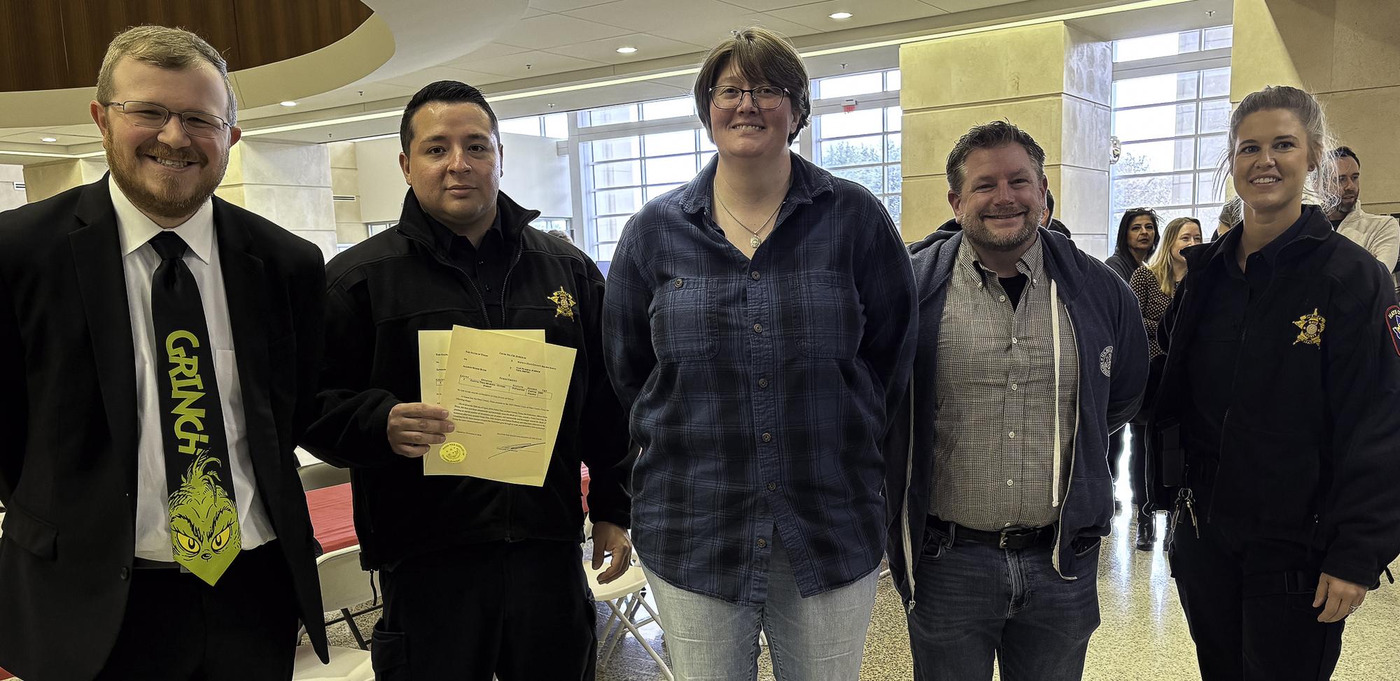 Landon Campbell from the DA’s Office, left, was handcuffed and charged with e...