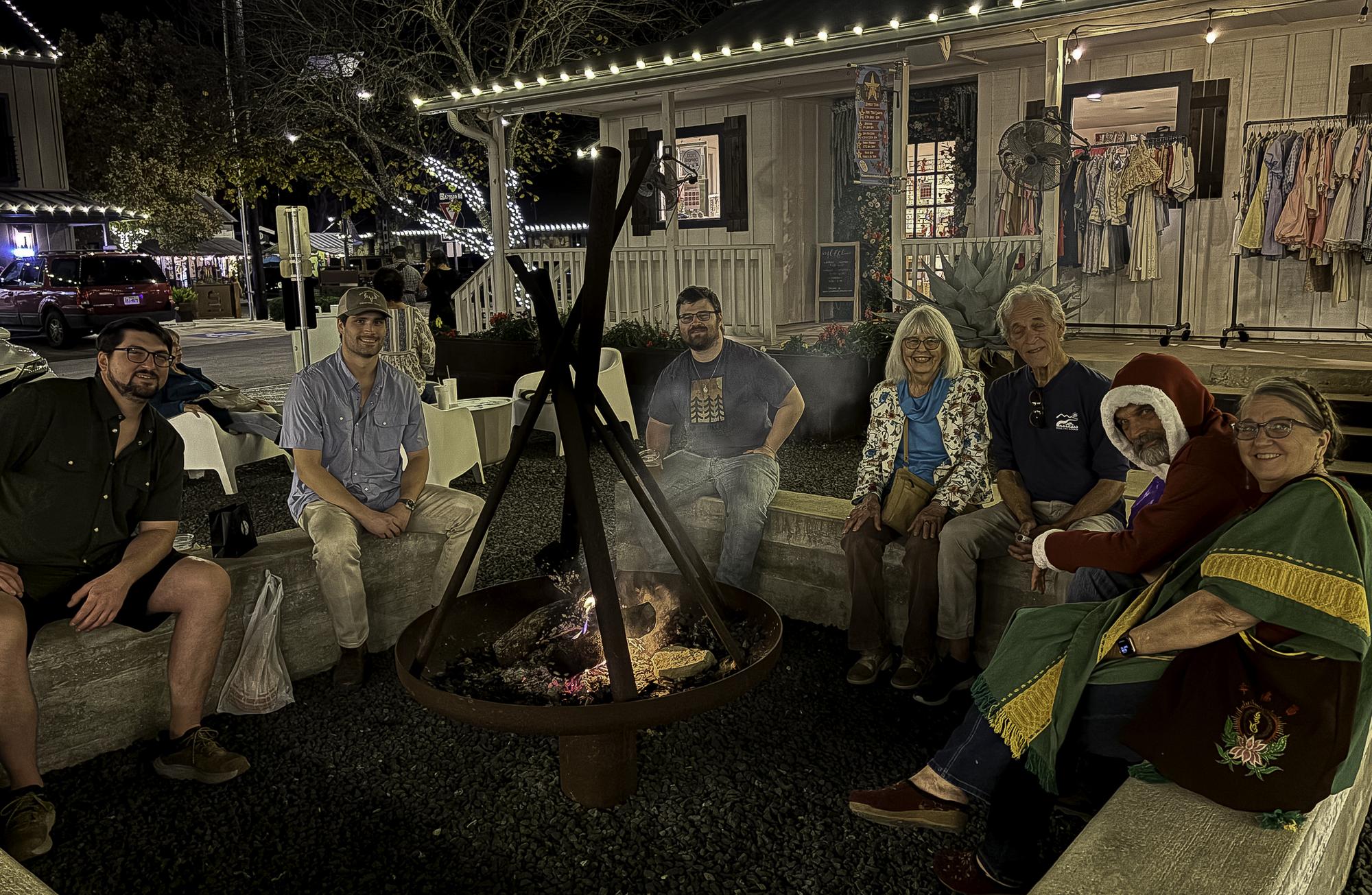 Photo by Teresa Kendrick Around the fire pit at Henson Square, shoppers enjoy...