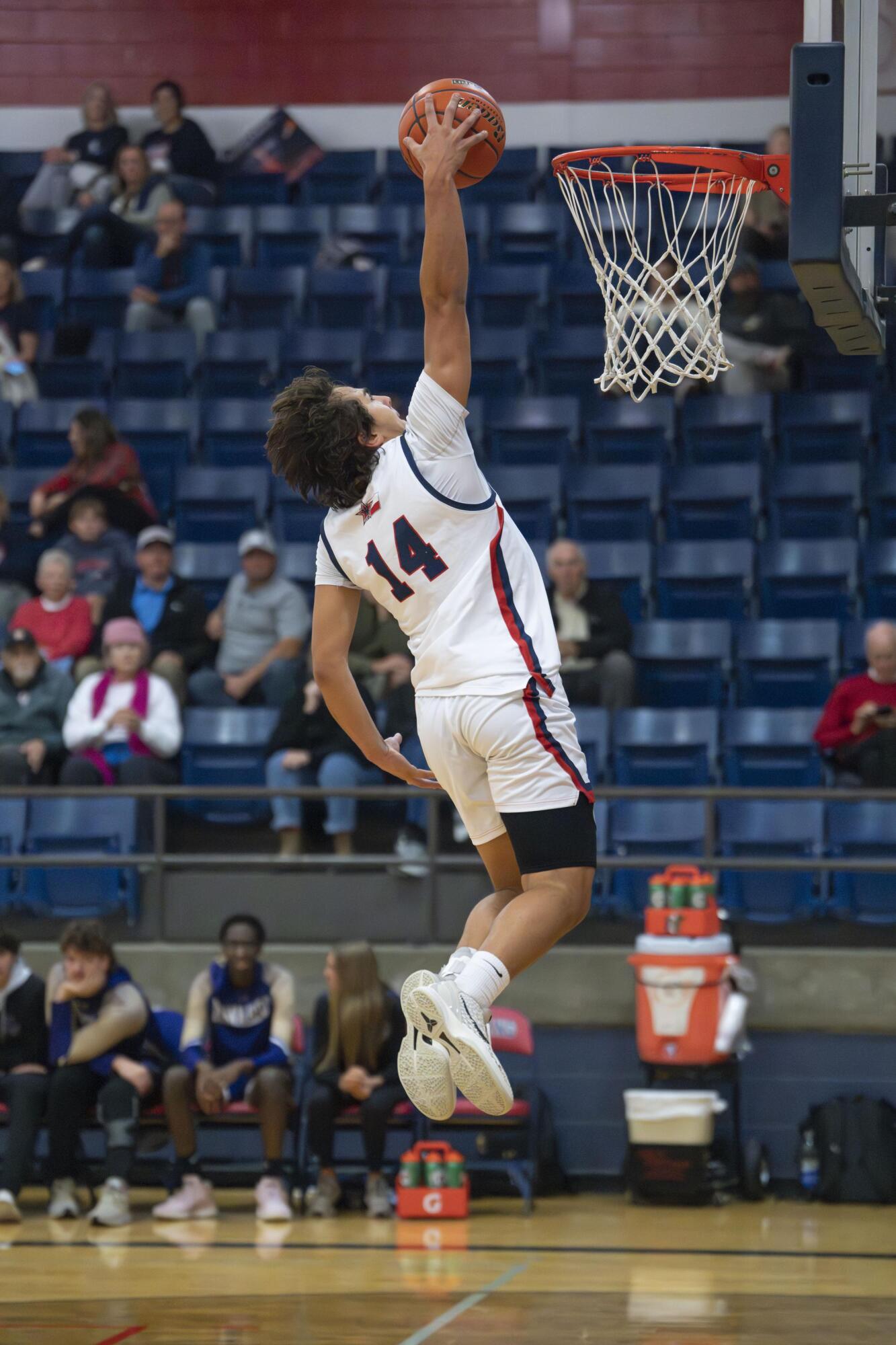 Paul Gumbert-Mendoza goes up for a slam. Photo by Julie Albini/albini.smugmug...